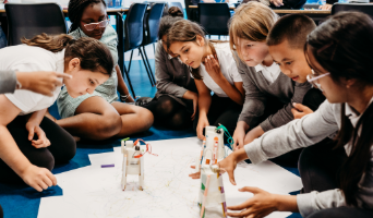upper primary students observing a science investigation in their classroom